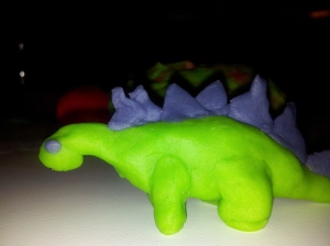 Picture of a green dinosaur with purple spikes, made of playdough